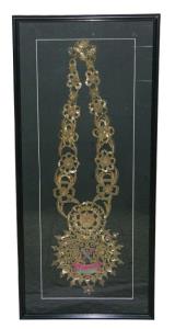 Embroidered garland of Datia State, with state coat of arms in center, and adorned by tins