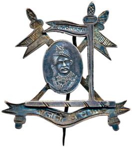 Cap Badge of Nawanagar State, Silver, portrait of Jam Vibhaji in the centre with three fla