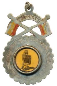 Gandhiji Medal, black and white photo of Gandhiji in center with a scalloped edge around, 