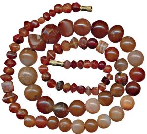 Beads, used for jewellery, a newly strung attractive necklace made from beads of red carne