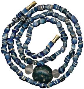 Beads, used for jewellery, a newly strung attractive necklace made from beads of blue stri