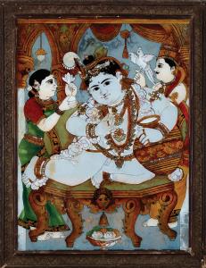 The plump child deity is depicted richly bejewelled, seated on an octagonal throne, eating
