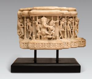 The elephant-headed deity seated with his consort in a central niche flanked by segmented 