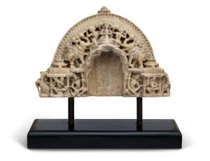 Carved in marble, the central niche with fragmentary seven headed cobra canopy, paired ele