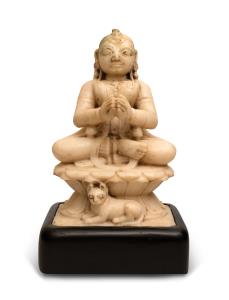 Seated on a lotus throne, her hands clasped in anjali mudra, her vehicle the lion resting 