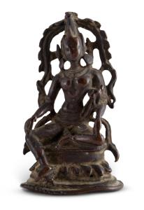 The deity seated in lalitasana, the posture of Royal Ease, with her left leg up on a lotus