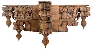 Each composed of two tiers of cruciform elements, terminating in scrolls with bud shaped p