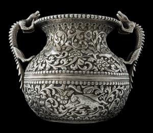 In the form of an Indian lota, with twin handles in the form of crocodiles, the chased and