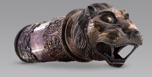 With lion-head terminal, the animal showing its fangs, naturalistically depicted with larg