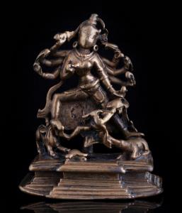 The multi-armed goddess on a raised stepped base, wielding various weapons to attack the d