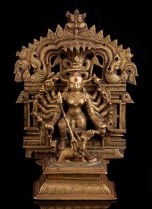 The sixteen-armed goddess on raised lotus base, wielding various weapons including the tri
