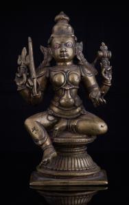 Seated in lalitasana on a waisted double lotus base, the four armed goddess holding triden