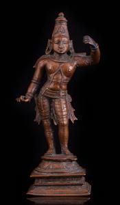 Standing in tribhanga on a raised lotus base, his left hand raised holding his bow (now mi