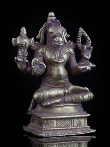 Seated in sattvasana, the God of knowledge and wisdom sits on a raised throne, his primary