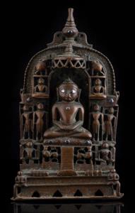 Inlaid with copper and silver, seated within an arch under a parasol, a kalasa finial abov
