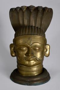 In three sections, the lingam with a moustachioed head of Shiva with prominent ears, his p