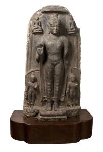 Of arched form, standing on a double lotus base under a parasol with right hand raised in 
