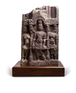 The central male figure standing in tribhanga in an arched columnar niche, flanked by a pa