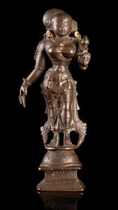 The goddess standing in ribhanga on a lotus base on raised square plinth, holding a padma 