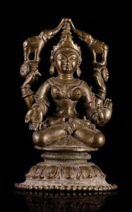 The four armed goddess seated in padmasana on a circular lotus base with beadwork rim foot