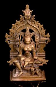 Seated in lalitasana with her vahana, the lion at her feet, the four-armed goddess holding
