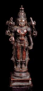 Standing on a circular lotus base on raised square plinth, his primary right hand in varad
