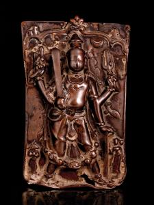 Of waisted rectangular form, the four-armed form of Shiva holding sword, shield, trident a
