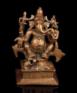 The four-armed, elephant headed deity seated with splayed legs on a lotus base, his vahana