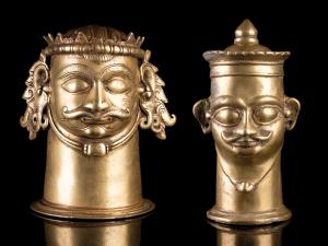 Each of cylindrical form with a moustachioed face of Shiva, one with tall headdress, crown