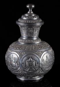 The spherical body surmounted by flared neck and domed lid, the chased and repousse relief