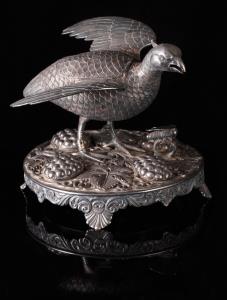 In the form of a quail with wings outstretched, a hinged lid to a compartment opening on h
