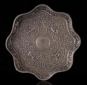 Of scalloped octagonal form, on four scrolling feet, the undecorated central roundel surro