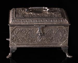 Of rectangular form, the hinged lid with serpentine handle, the four bracket legs resting 