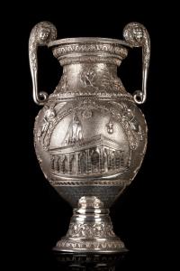 In the form of a classical volute krater, with twin scrolling handles decorated with horne