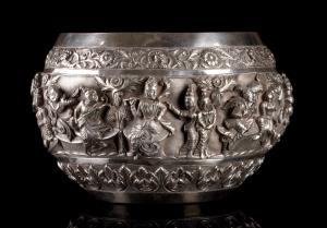 Of compressed spherical form, with folded-in rim, the body with repousse decoration in hig