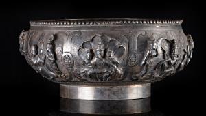 Of compressed spherical form, standing on rim foot, the sides with a series of scenes divi