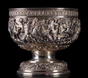 Of hemispherical form on flared rim foot, the sides decorated with a continuous chased and