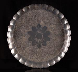 The chased and repousse decoration comprising a central floral medallion surrounded by den